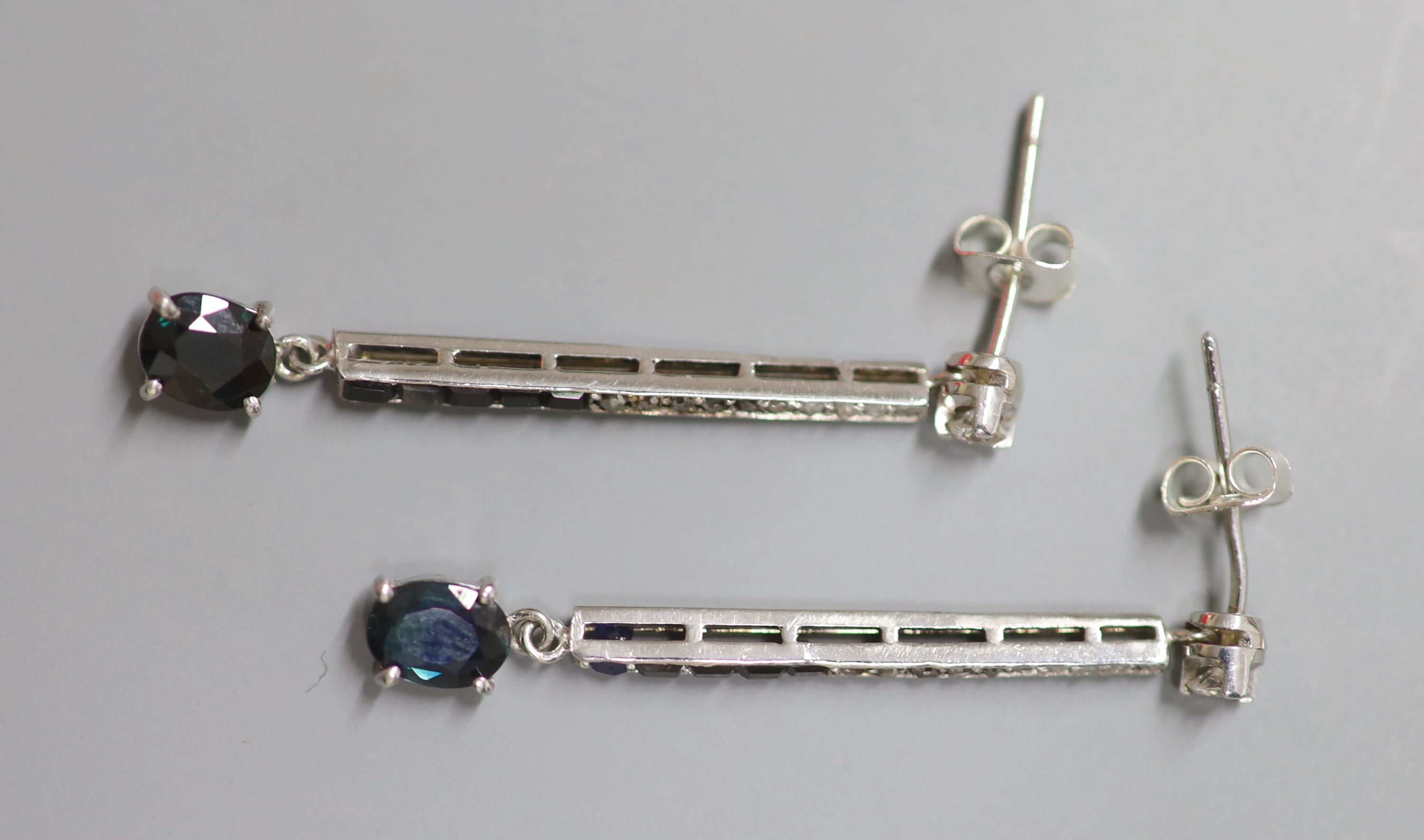 A pair of white metal, sapphire, black onyx, rose and round cut diamond set line drop earrings, 38mm, gross 3.6 grams.